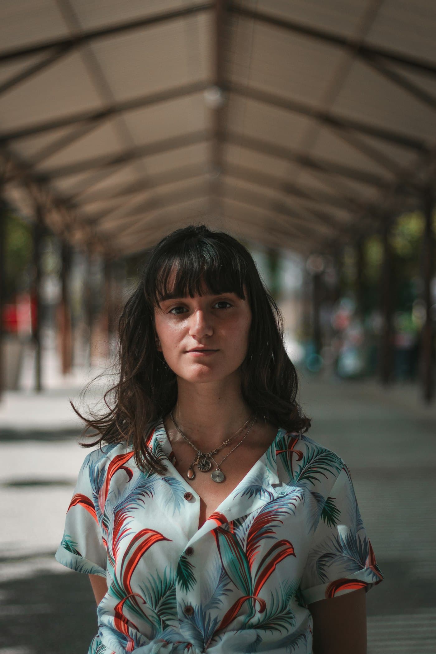 Girl in a patterned vintage shirt at a covered market