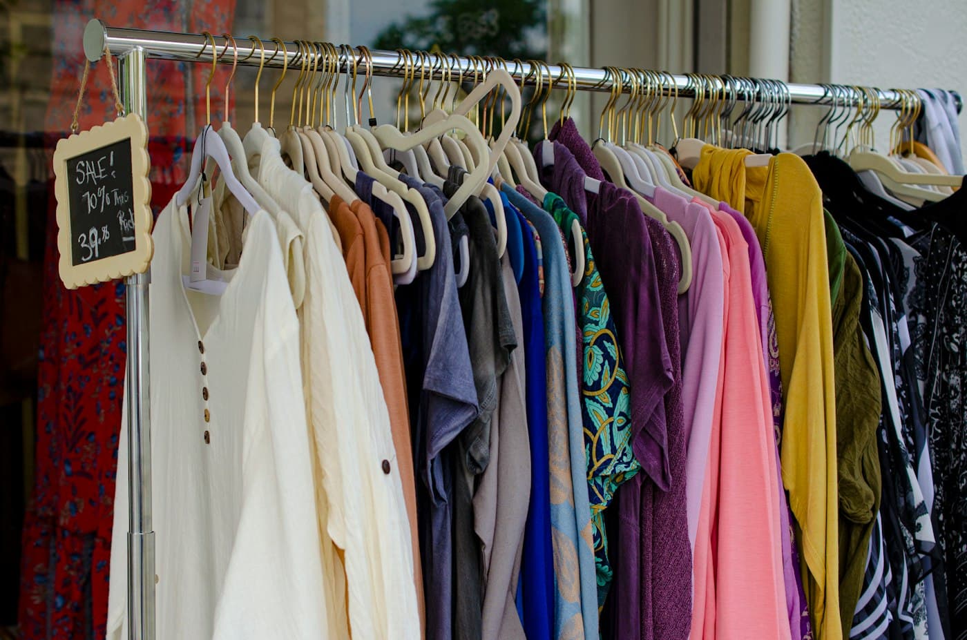 Rail of pastel blouses and shirts